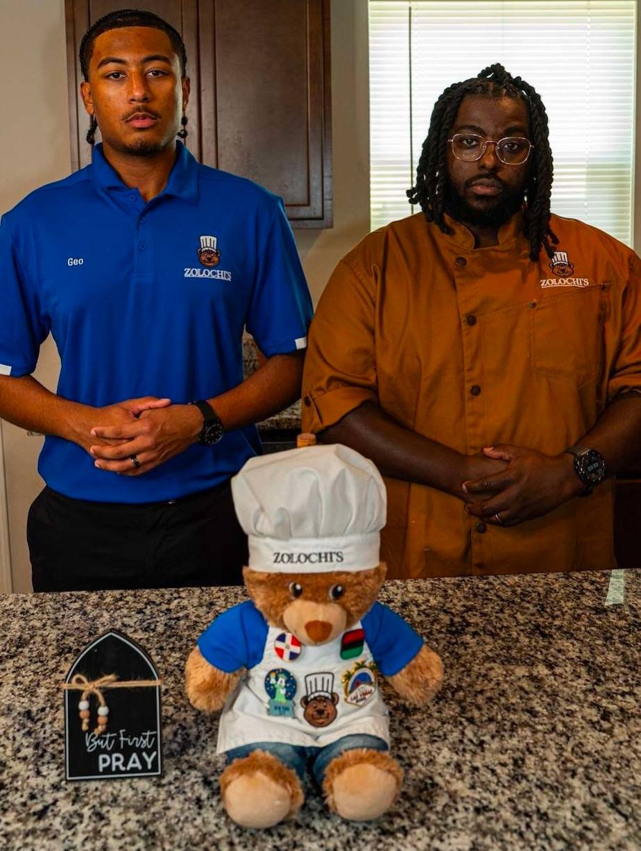 Zolochi the bear with the founders behind him